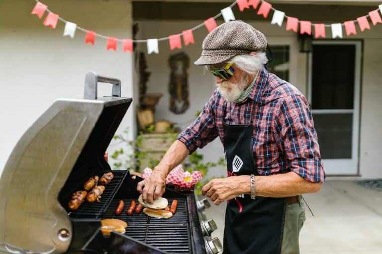 man cooking on a pellet grill